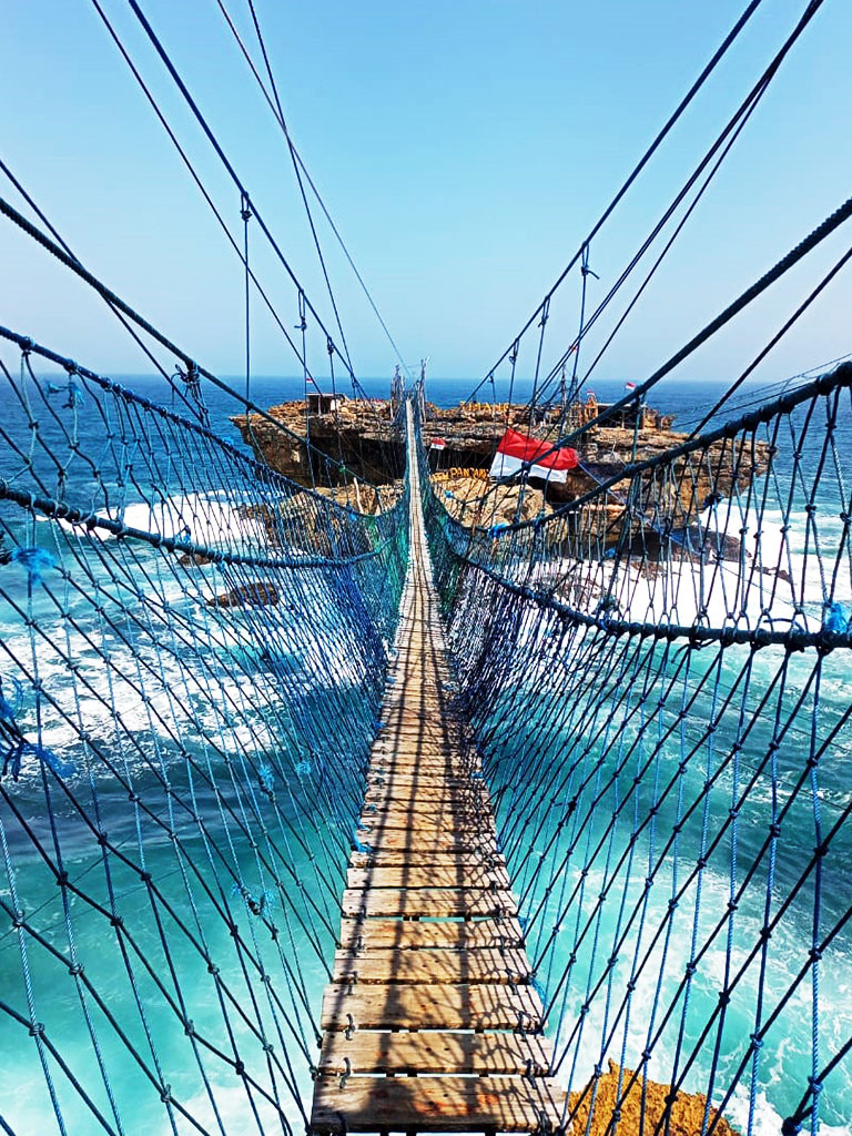 Suspension Bridge to Watu Panjang island with safety net in both side
