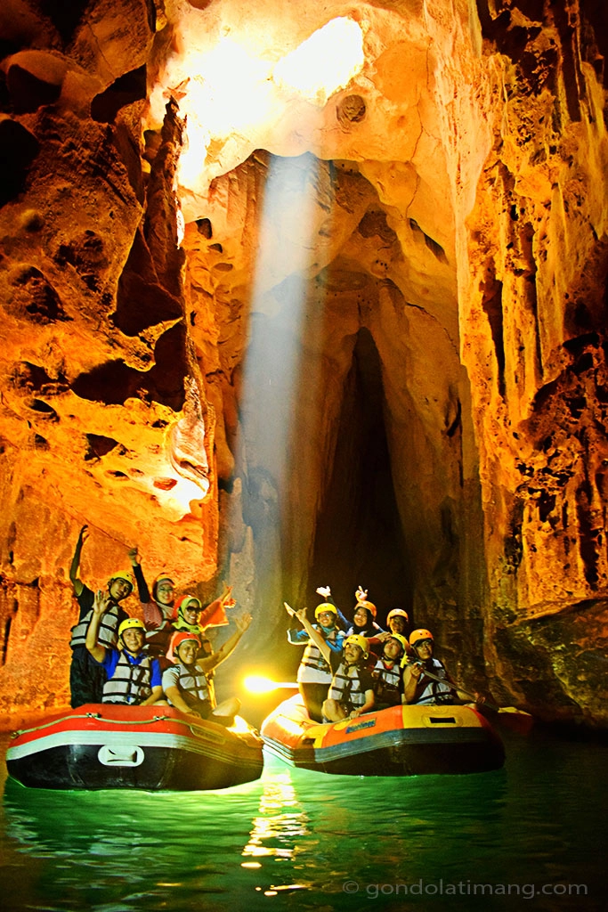 Explore mysterious Tanding cave by rowing rubber boat.