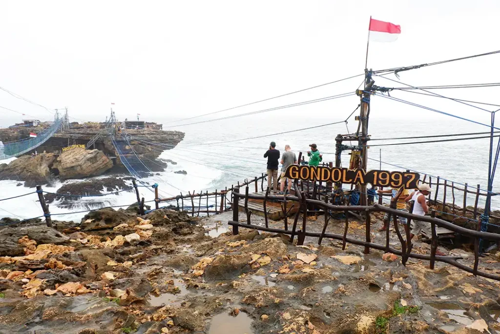Several villagers working as Timang Gondola pullers on a rainy day.