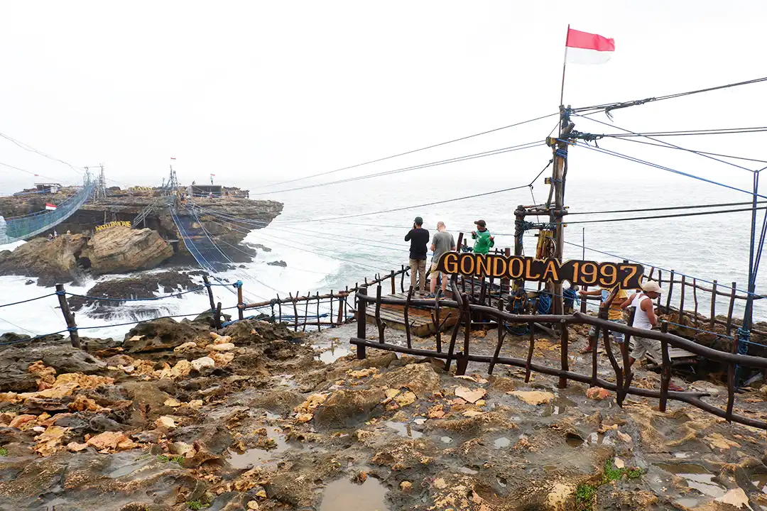 Several villagers working as Timang Gondola pullers on a rainy day.